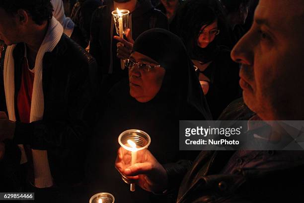 People hold candles during a vigil for victims of a Sunday bombing at a Coptic cathedral, in downtown Cairo, Egypt, Wednesday, Dec. 14, 2016. Twenty...