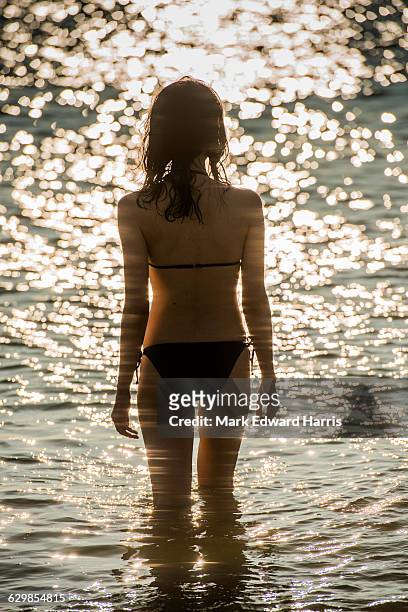 woman in the surf on the big island of hawaii - anaehoomalu bay stockfoto's en -beelden