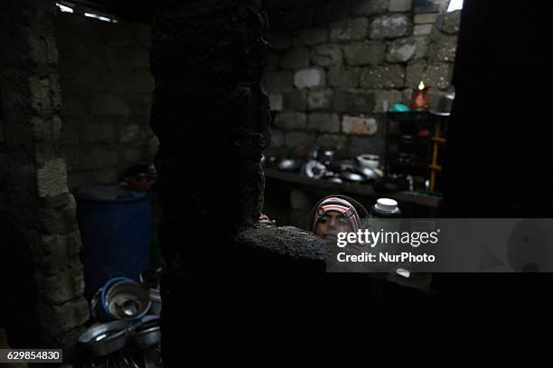 Palestinian boy look in Sharm flowers slums on the outskirts of the Khan Younis refugee camp, southern Gaza Strip on December 14, 2016 and the...