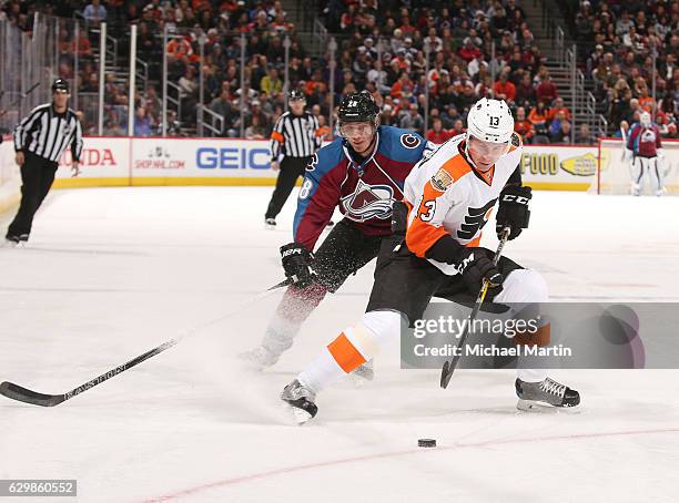 Roman Lyubimov of the Philadelphia Flyers skates in front of Patrick Wiercioch of the Colorado Avalanche at the Pepsi Center on December 14, 2016 in...