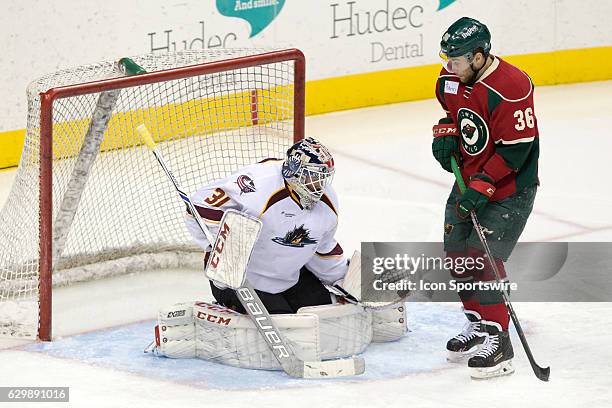 Cleveland Monsters G Anton Forsberg makes a stop as Iowa Wild LW Colton Beck looks for a rebound during the third period of the AHL hockey game...