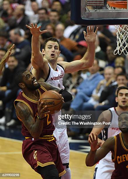 Washington Wizards forward Jason Smith tries to block the shot by Cleveland Cavaliers guard Kyrie Irving during the second half of the game between...