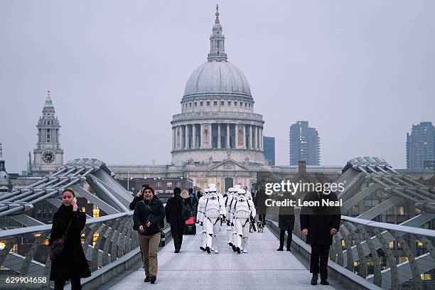 People dressed as Stormtroopers from the Star Wars franchise of films pose on the Millennium Bridge to promote the latest release in the series,...