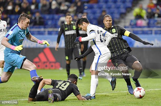 Yasushi Endo of J-League champions Kashima Antlers scores a goal with his heel during the second half of a Club World Cup semifinal against South...