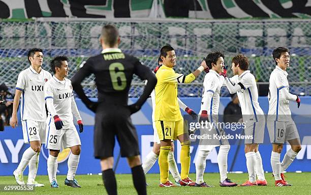 Players of J-League champions Kashima Antlers celebrate after defeating South American champions Atletico Nacional 3-0 in a Club World Cup semifinal...