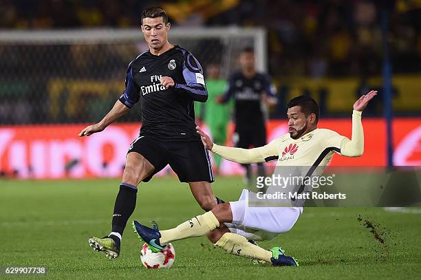 Miguel Samudio of Club America competes for the ball against Cristiano Ronaldo of Real Madrid during the FIFA Club World Cup Japan semi-final match...