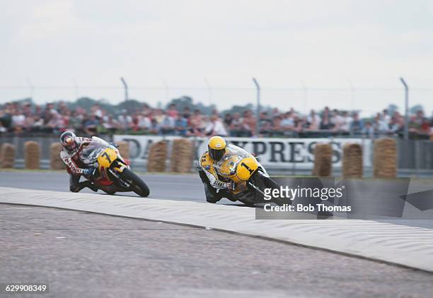 Barry Sheene of Great Britain rides the Yamaha YZR 500 alongside rival Kenny Roberts of the United States riding the Yamaha YZR 500 during British...
