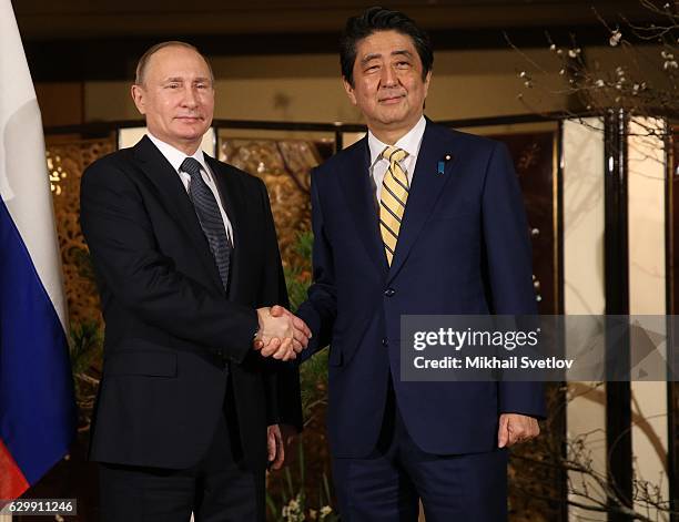 Russian President Vladimir Putin shakes hands with Japanese Prime Minister Shinzo Abe during the official reception ceremony on December 15, 2016 in...