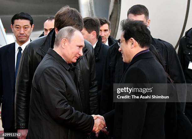 Russian President Vladimir Putin is welcomed by Japanese Foreign Minister Fumio Kishida on arrival at Yamaguchi Ube Airport on December 15, 2016 in...
