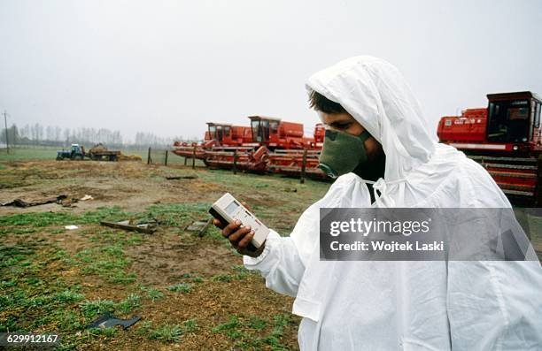 Man is measuring levels of radioactivity in the area surrounding the Chernobyl nuclear power plant four years after the disaster. Chernobyl, Ukraine,...