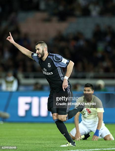 Real Madrid's French forward Karim Benzema celebrates after scoring a goal as Club America's defender Paolo Goltz looks on during the Club World Cup...