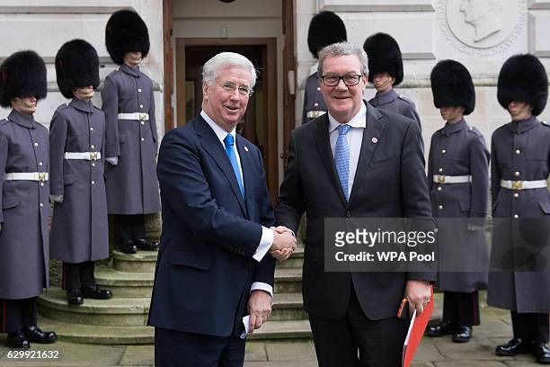 Defence Secretary Sir Michael Fallon greets Australian High Commissioner, Alexander Downer outside the Foreign Office ahead of a London summit with...