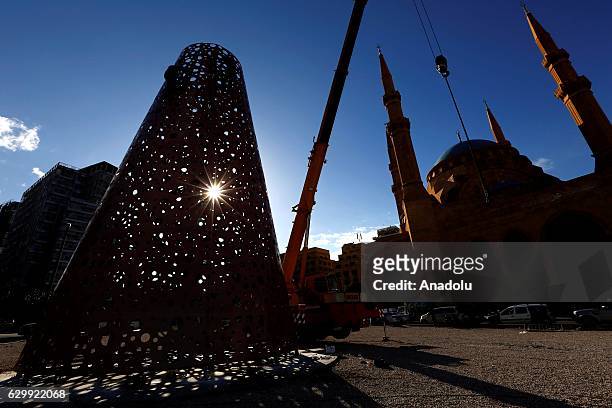 Beirut municipality workers assemble Christmas trees and decorations at the Martyrs' Square in Beirut, Lebanon on December 15, 2016.