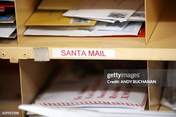 Envelopes addressed to Santa Claus sit in a cubicle at a Royal Mail Distribution centre in Glasgow in what is traditionally the busiest day of the...