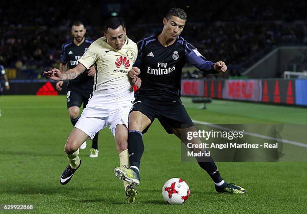 Cristiano Ronaldo of Real Madrid competes for the ball with Rubens Sambueza of Club America during the FIFA Club World Cup semi final match between...