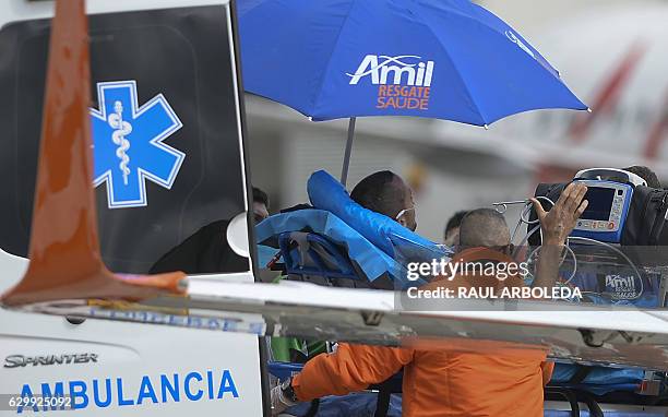 Brazilian doctors carry Chapecoense football player and plane crash survivor Helio Neto to a plane departing to Brazil, in Rionegro, Antioquia...