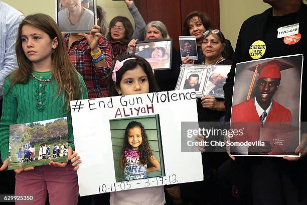 More than 80 family members and friends of people who were killed by gun violence gather for a news conference with Congressional Democrats to call...