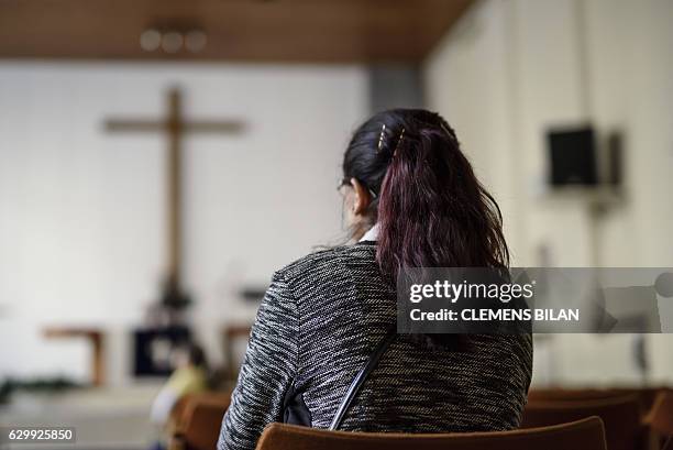 Afghan refugee Faridah visits a course preparing her to convert into christian confession by baptism in Berlin, on October 23, 2016. / AFP / CLEMENS...