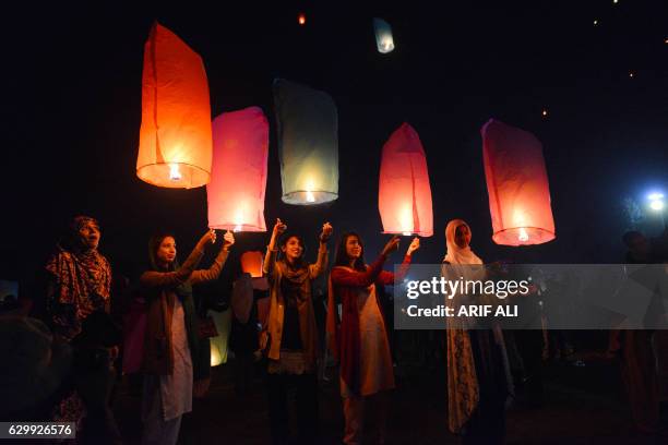 Pakistani civil society activists release lanterns into the sky in Lahore on December 15 as they pay tribute to victims on the second anniversary of...