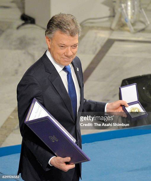 Colombia President Juan Manuel Santos receives his certificate and medal during the Nobel Peace Prize ceremony at Oslo Town Hall on December 10, 2016...