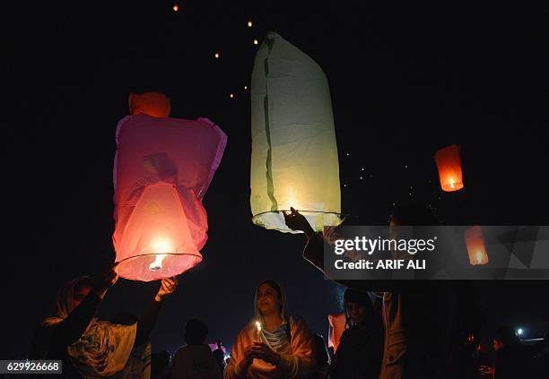 Pakistani civil society activists release lanterns into the sky in Lahore on December 15 as they pay tribute to victims on the second anniversary of...