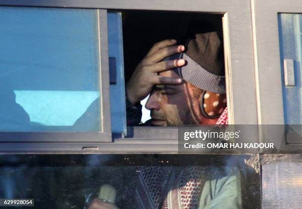 Syrian, who was evacuated from rebel-held neighbourhoods in the embattled city of Aleppo, reacts as he arrives in the opposition-controlled Khan...