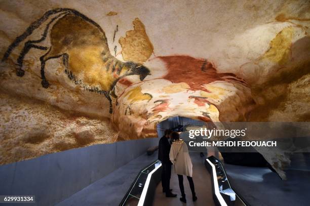 People visit the new replica of the Lascaux cave paintings during the first public opening on December 15, 2016 in Montignac, in the Dordogne region...
