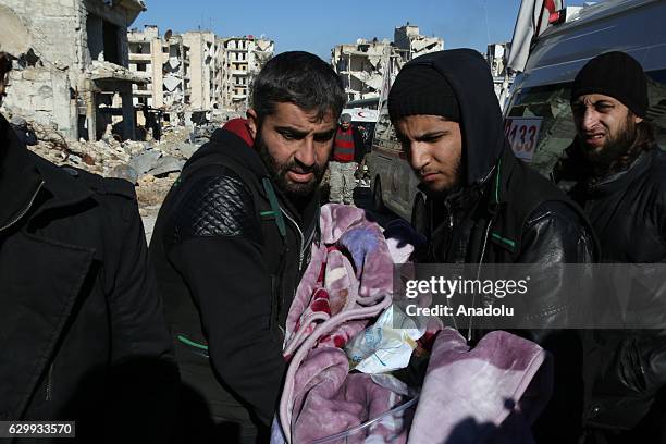 Wounded civilians arrive for a convoy, including buses and ambulances, wait at a crossing point at Amiriyah District of Aleppo Syria on December 15,...