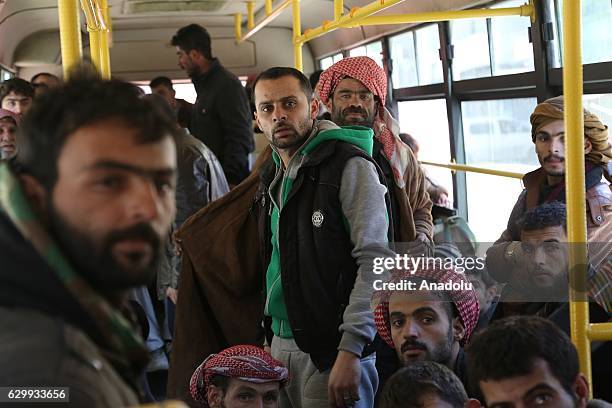 Convoy including busses and ambulances, wait at a crossing point at Amiriyah District of Aleppo Syria on December 15, 2016 to evacuate civilians,...