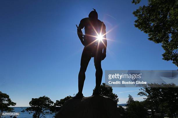 The morning sun shines through the statue of Wampanoag Indian chief Massasoit which stands atop a hill overlooking Plymouth Rock in Plymouth, MA on...