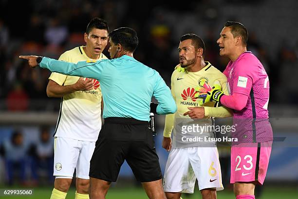 The match referee refers a decision to the video assistant referee during the FIFA Club World Cup Semi Final match between Club America and Real...