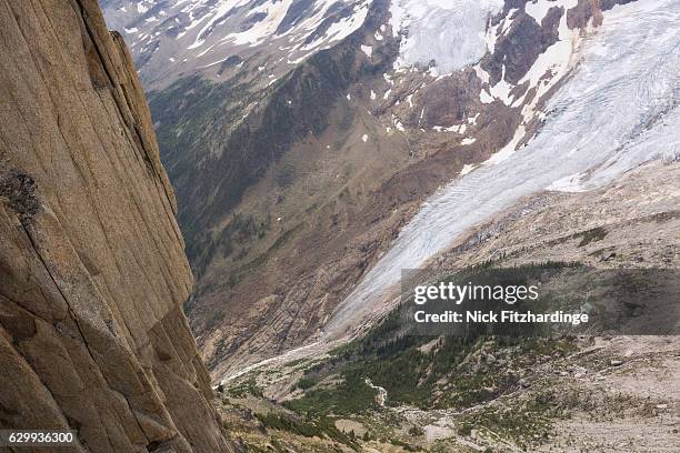 glacial tongue and cliffface from the summit of eastpost spire, bugaboo provincial park, british columbia, canada - bugaboo glacier provincial park stock pictures, royalty-free photos & images