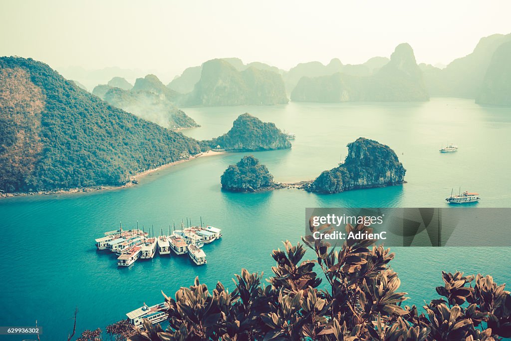 High point of view on old boats cruising around through Halong Bay