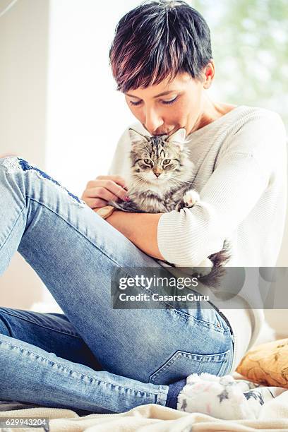 happy woman portrait with her cat - cat lady stock pictures, royalty-free photos & images