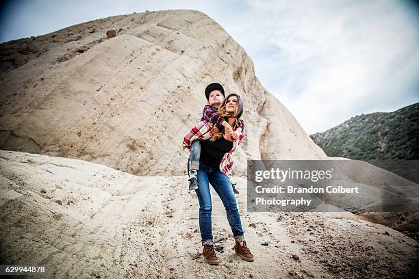 mother and son - woman child piggyback stock-fotos und bilder