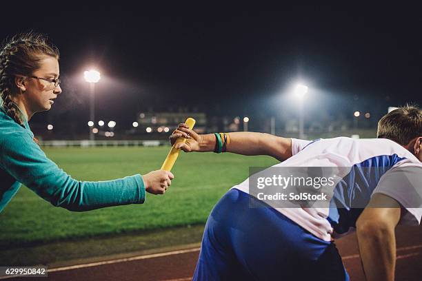 passing on the baton - track and field baton stock pictures, royalty-free photos & images