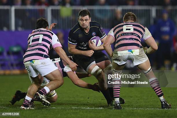 Elliott Stooke of Bath runs at Brad Thyer and Macauley Cook of Cardiff during the European Rugby Challenge Cup match between Bath Rugby and Cardiff...