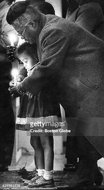 Elma Lewis shows a child how to hold a candle during a rehearsal for the Afro-American Artists' production of Langston Hughes' "Black Nativity" in...