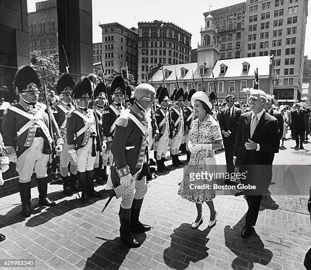 Mayor Kevin White escorts Queen Elizabeth II through Washington Mall in Boston on the way to City Hall ceremonies as Colonel Vincent J. R. Kehoe,...