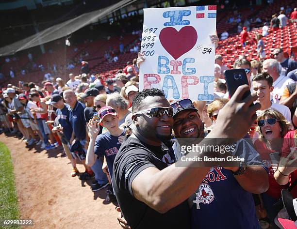 Red Sox David Ortiz takes a selfie with a fan during on field photo day at Fenway Park in Boston on Sep. 6, 2015.