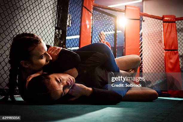 females wrestling on the canvas - headlock stock pictures, royalty-free photos & images