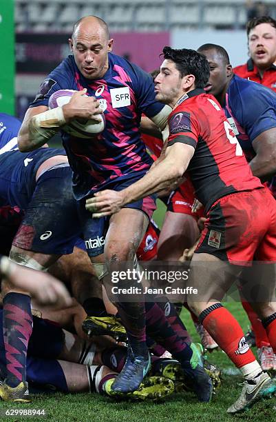 Sergio Parisse of Stade Francais and Sam Hidalgo-Clyne of Edinburgh in action during the European Rugby Challenge Cup match between Stade Francais...