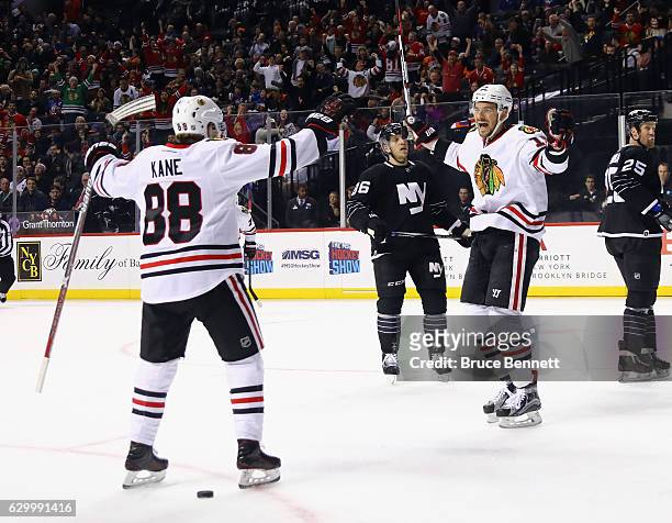 Artem Anisimov of the Chicago Blackhawks scores at 15:03 of the first period against the New York Islanders and is joined by Patrick Kane at the...