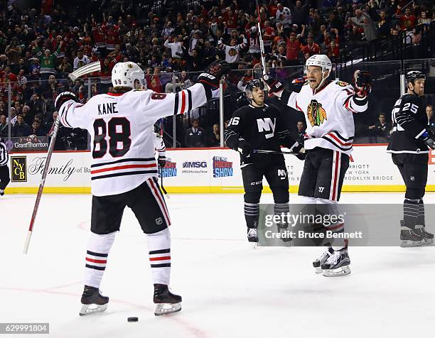 Artem Anisimov of the Chicago Blackhawks scores at 15:03 of the first period against the New York Islanders and is joined by Patrick Kane at the...