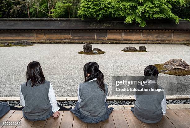 School-girls at zen rock garden, Ryoanji, Ryoan-ji Temple, Kyoto, Japan.