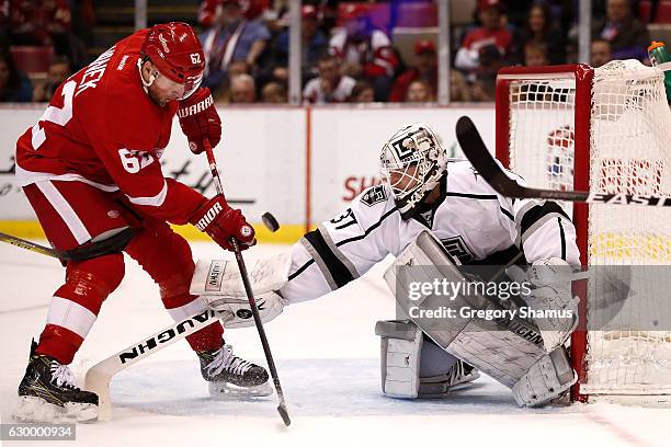 Jeff Zatkoff of the Los Angeles Kings pokes the puck away from Thomas Vanek of the Detroit Red Wings during the second period at Joe Louis Arena on...