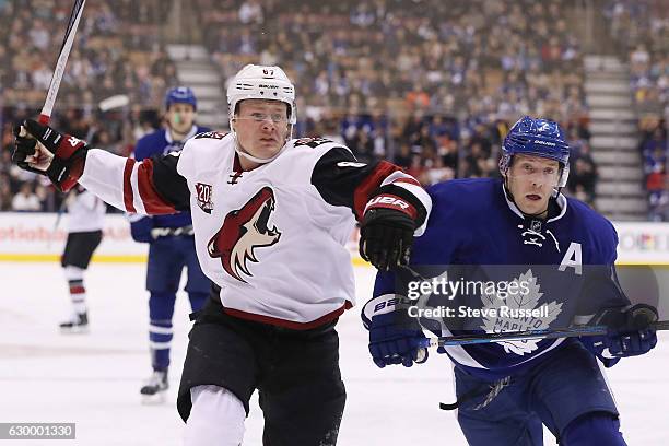 Arizona Coyotes left wing Lawson Crouse looks for way around Toronto Maple Leafs defenseman Matt Hunwick as the Toronto Maple Leafs play the Arizona...