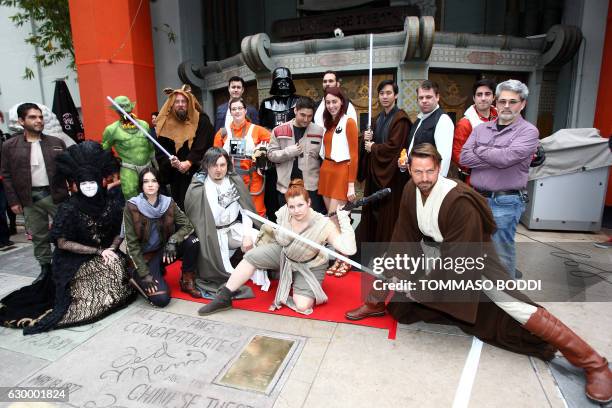 Fans pose for a photo after a costume contest of Star Wars fans lining up to see 'Rogue One: A Star Wars Story' at the TCL Chinese Theatre in...