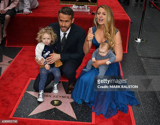 Actor Ryan Reynolds holds his daughter James as his wife Blake Lively holds their unnamed new baby during the Deadpool actors Hollywood Walk of Fame...