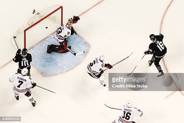 Andrew Ladd of the New York Islanders shots the puck past Scott Darling of the Chicago Blackhawks for a first period goal at the Barclays Center on...